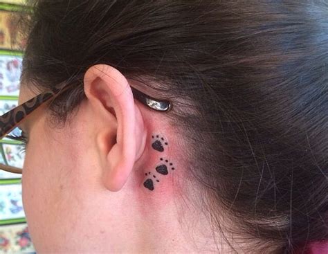 paw print tattoo behind ear meaning: What does it say about the wearer's personality?